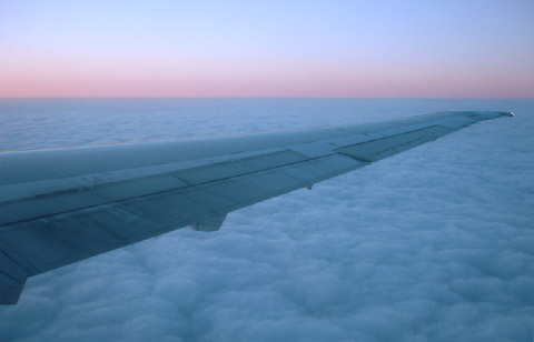 airplane wing above the clouds