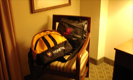 A photo of luggage on a hotel room chair
